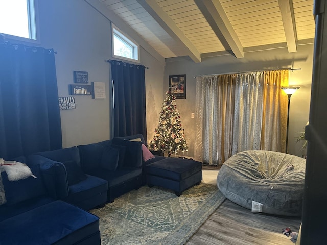 living room featuring hardwood / wood-style floors, beamed ceiling, and high vaulted ceiling