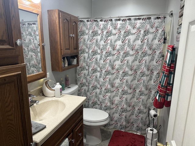 bathroom with tile patterned floors, curtained shower, vanity, and toilet