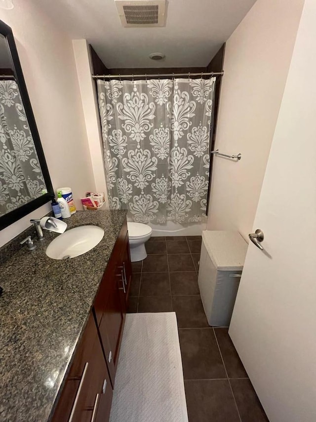 bathroom featuring toilet, vanity, and tile patterned floors