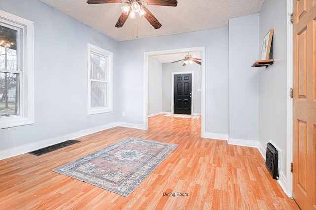 interior space featuring light hardwood / wood-style floors and a textured ceiling