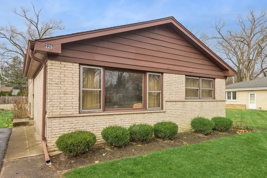 view of home's exterior with a lawn