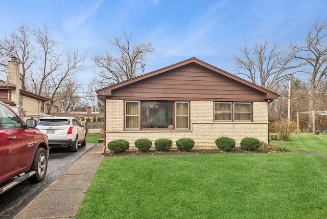 view of side of home with a lawn