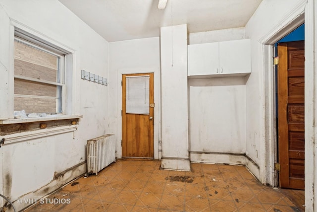 interior space featuring white cabinetry and radiator heating unit