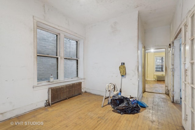 interior space with light hardwood / wood-style flooring and radiator