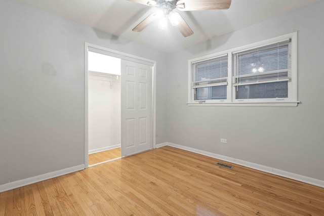 unfurnished bedroom featuring ceiling fan, light hardwood / wood-style flooring, and a closet