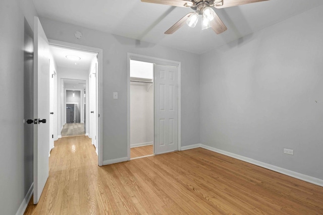 unfurnished bedroom featuring ceiling fan, light hardwood / wood-style flooring, and a closet