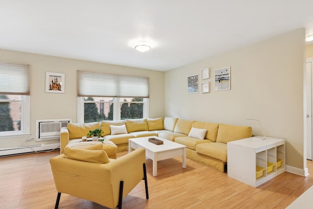 living room with a baseboard heating unit, hardwood / wood-style floors, and a wall mounted air conditioner