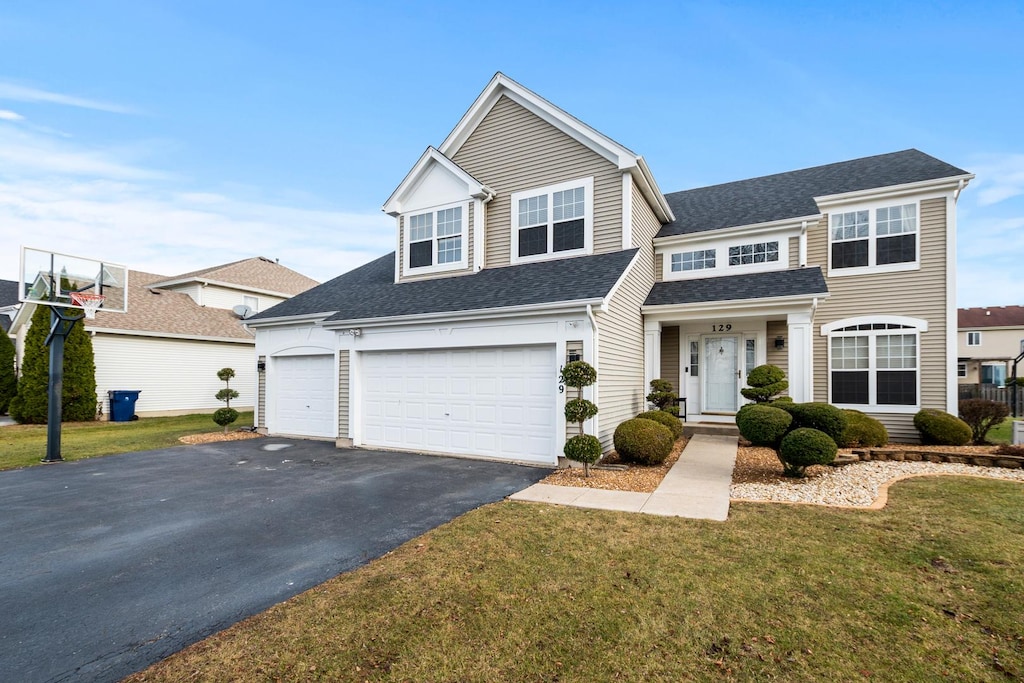 view of front of property with a front lawn and a garage