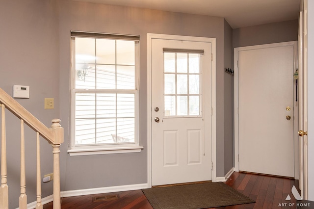 doorway to outside featuring dark wood-type flooring