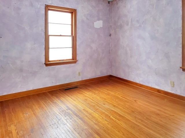 spare room featuring hardwood / wood-style flooring