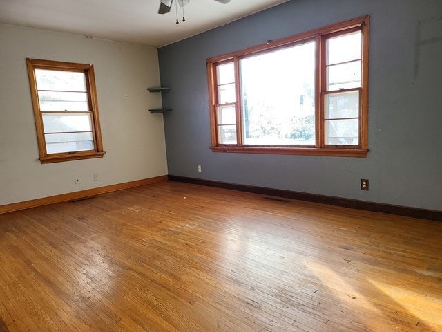 unfurnished room with light hardwood / wood-style flooring and ceiling fan