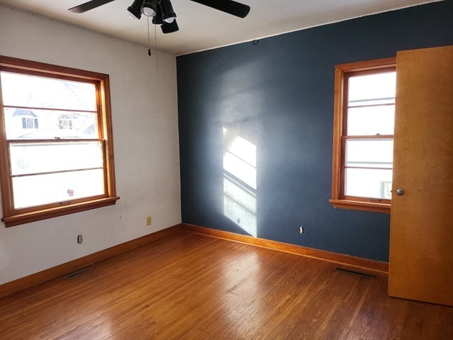 spare room featuring ceiling fan and hardwood / wood-style flooring