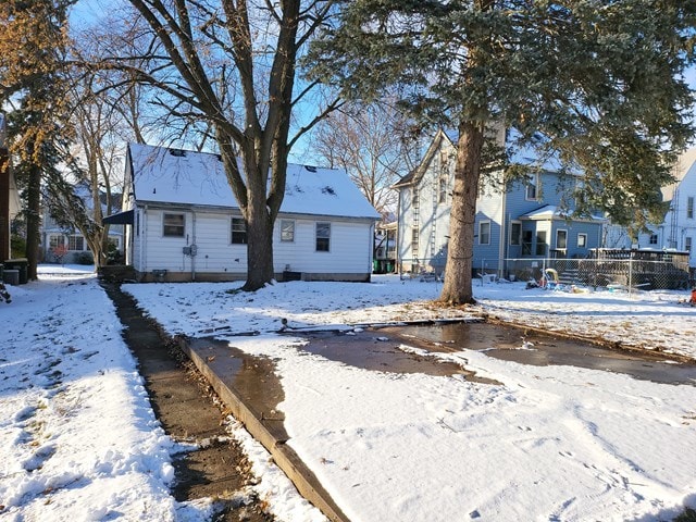 view of snow covered rear of property