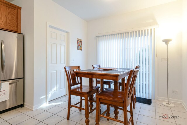 dining space featuring light tile patterned floors