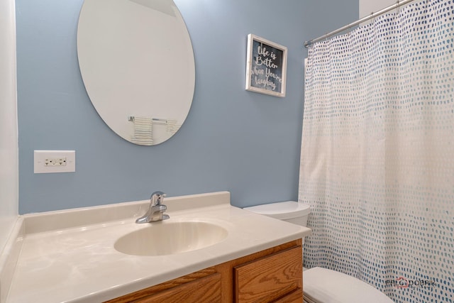 bathroom featuring toilet and vanity