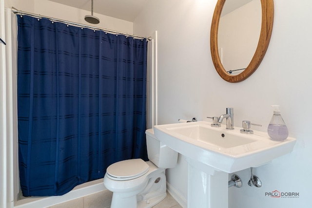 bathroom featuring toilet, tile patterned flooring, and a shower with curtain