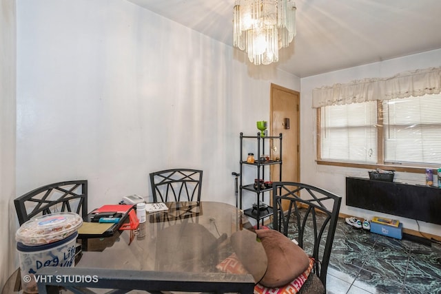 tiled dining room featuring a notable chandelier