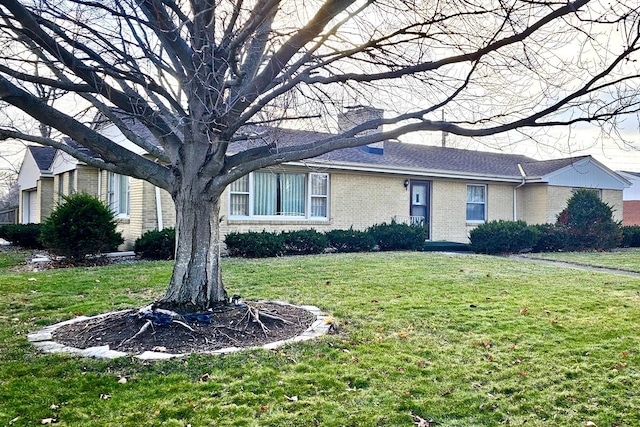 ranch-style home featuring a front yard