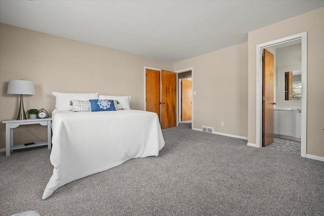 bedroom featuring carpet floors and ensuite bath