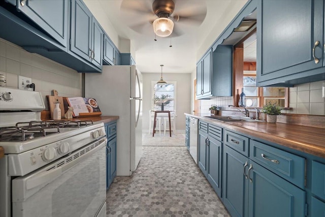 kitchen with dishwashing machine, wood counters, sink, white range with gas stovetop, and blue cabinets