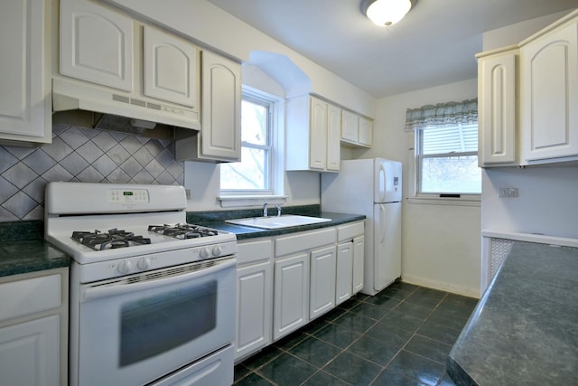 kitchen featuring white appliances, exhaust hood, sink, tasteful backsplash, and white cabinetry