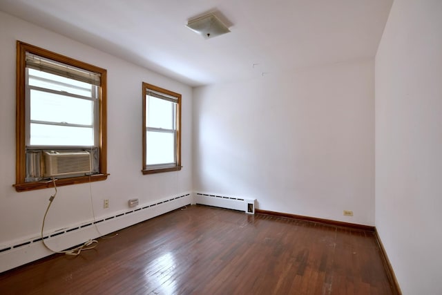 empty room with cooling unit, dark hardwood / wood-style flooring, and a baseboard radiator