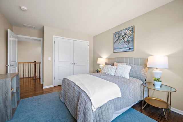 bedroom with a closet and dark hardwood / wood-style floors