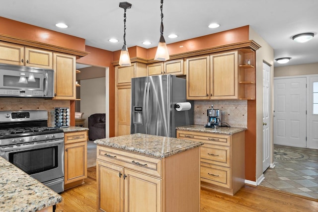 kitchen featuring pendant lighting, a center island, light hardwood / wood-style flooring, tasteful backsplash, and stainless steel appliances