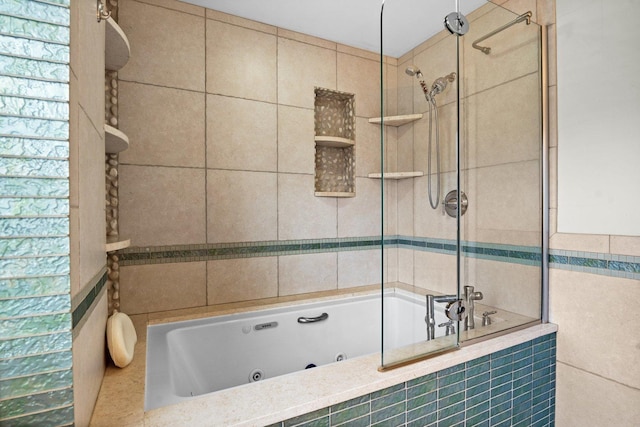 bathroom featuring tiled shower / bath and tile walls