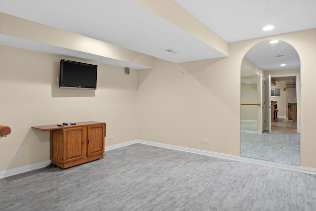 basement with light hardwood / wood-style floors