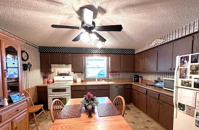 kitchen with ceiling fan, sink, a textured ceiling, white appliances, and dark brown cabinets