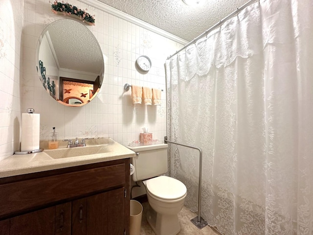 bathroom with ornamental molding, a textured ceiling, and tile walls