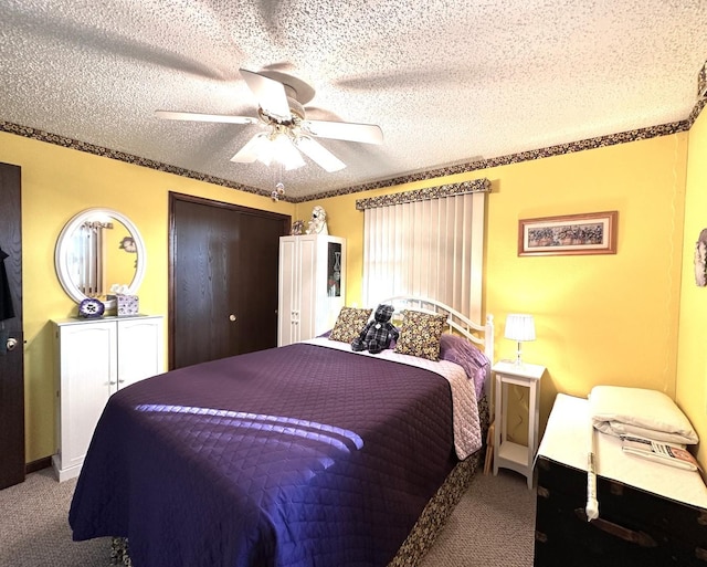 carpeted bedroom featuring ceiling fan and a textured ceiling