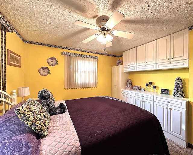 carpeted bedroom featuring ceiling fan and a textured ceiling