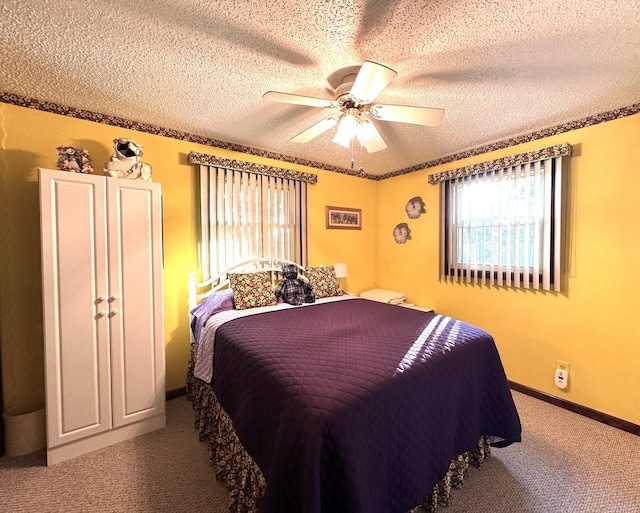 carpeted bedroom with ceiling fan and a textured ceiling