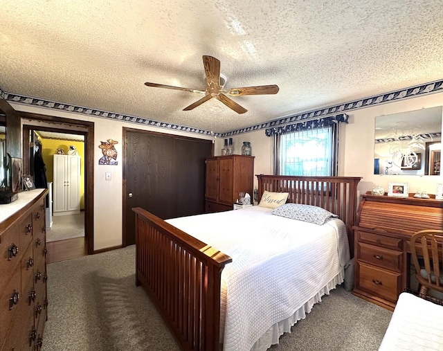 bedroom with a textured ceiling, light colored carpet, and ceiling fan