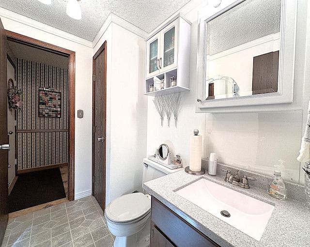 bathroom with tile patterned floors, vanity, toilet, and a textured ceiling