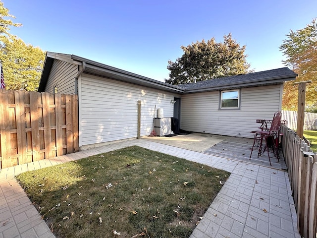 rear view of house with a patio area and a yard