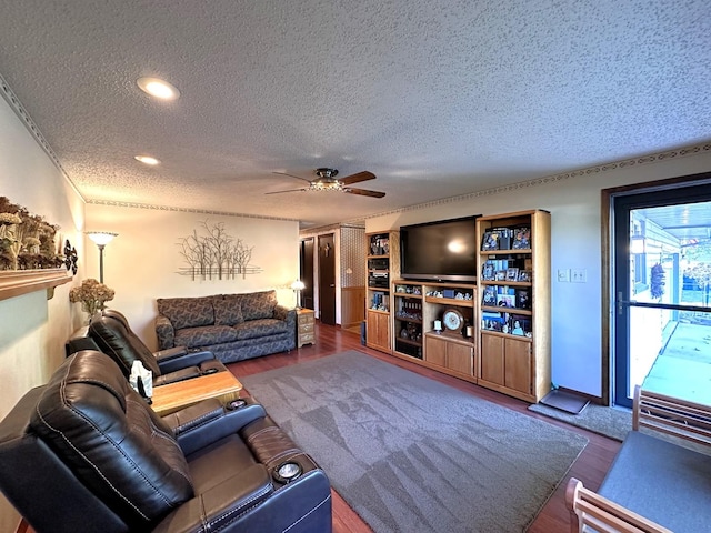 living room with wood-type flooring, a textured ceiling, a wealth of natural light, and ornamental molding