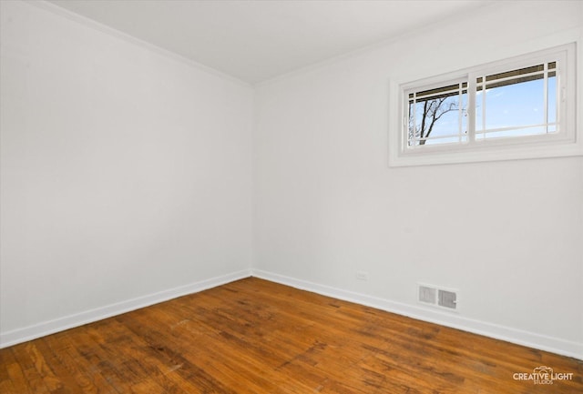 unfurnished room with wood-type flooring and crown molding