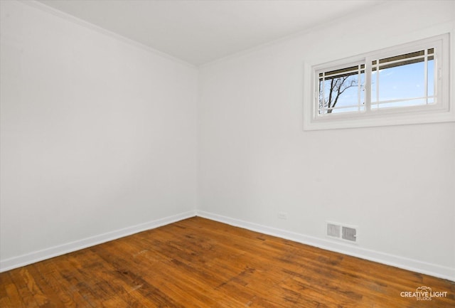 7825 N Oconto Ave, Niles, IL 60714 - empty room with wood finished floors and crown molding