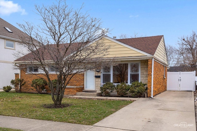 7825 N Oconto Ave, Niles, IL 60714 - view of front of house featuring a gate, a front yard, brick siding, and driveway
