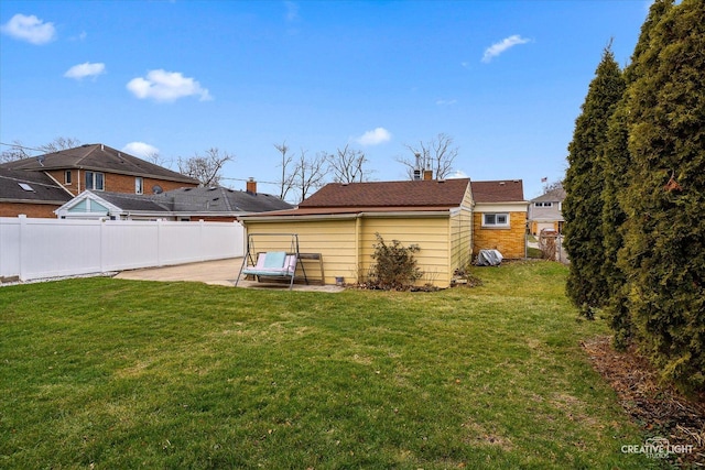 rear view of house featuring a yard and a patio area