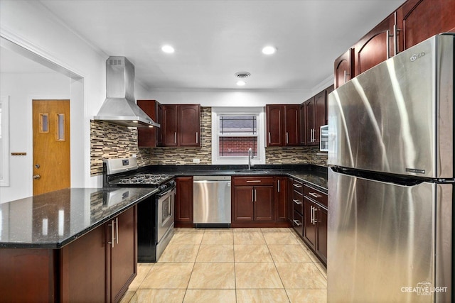 kitchen with dark stone countertops, stainless steel appliances, ornamental molding, and wall chimney range hood