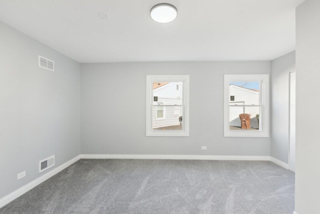 unfurnished room with light carpet