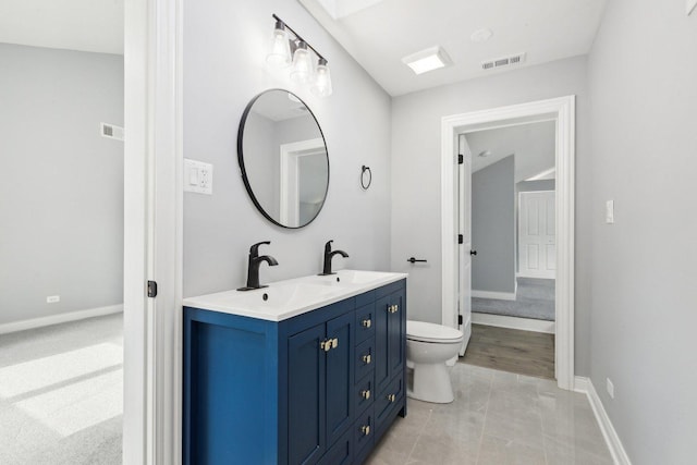 bathroom with tile patterned floors, vanity, and toilet