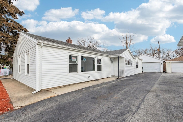 view of front of house featuring an outbuilding and a garage