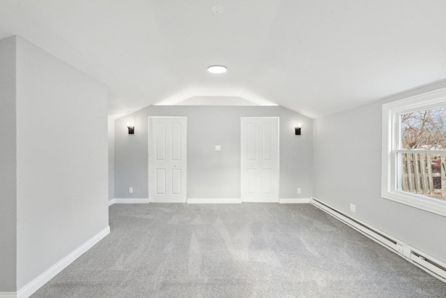 bonus room featuring carpet, vaulted ceiling, and a baseboard heating unit