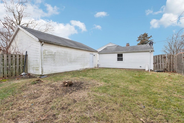 rear view of property featuring a yard