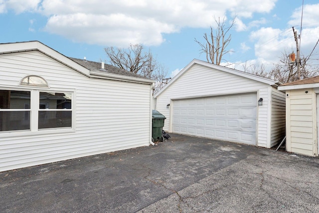 view of side of home with a garage and an outdoor structure